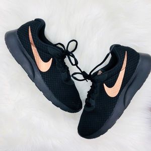 black nike shoes with rose gold swoosh